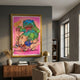Ouchh!! Canvas Wall Art by Giant Sculptures in a gold frame, showing a green monster crushing a cartoon pig with CRACK!! and OUCHHH!! lettering, above a walnut sideboard.
