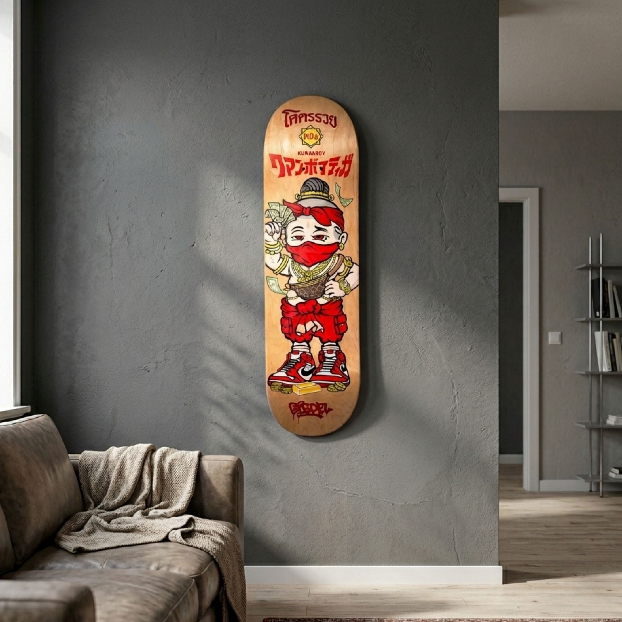 Kuman Boy Deck Vol.2 Skateboard Wall Art by Giant Sculptures, featuring a masked cartoon figure in red with gold chains and cash, mounted on a grey living room wall.