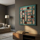 Formexa Ring Geometric Wood Relief 3D Wall Art by Giant Sculptures, teal board with red, pink, and blue rings in curved wood slots, mounted in a modern living room.