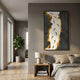 Prosper Black & Amber Metallic Fish 3D Relief Wall Art by Giant Sculptures displayed above a bedside table in a modern bedroom with a fiddle leaf fig.