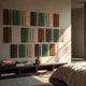 Eximia Brown & Green Tones Multi-Panel Wood Relief 3D Wall Art by Giant Sculptures, displayed above a low wooden console in a sunlit bedroom.