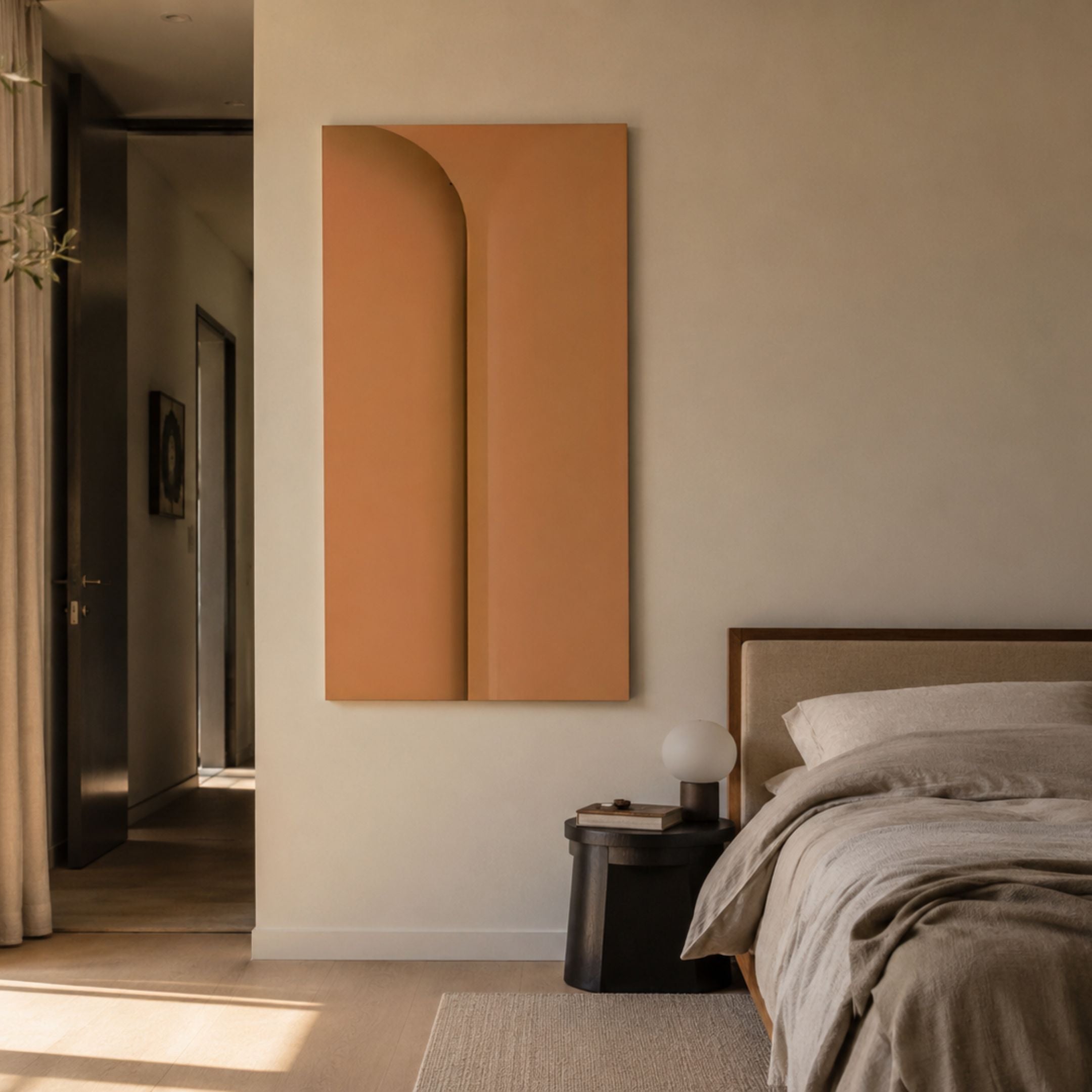 Eximia Sienna Minimalist Wood Relief 3D Wall Art by Giant Sculptures, a tall sienna panel with a carved arched indentation, displayed above a bedside table.