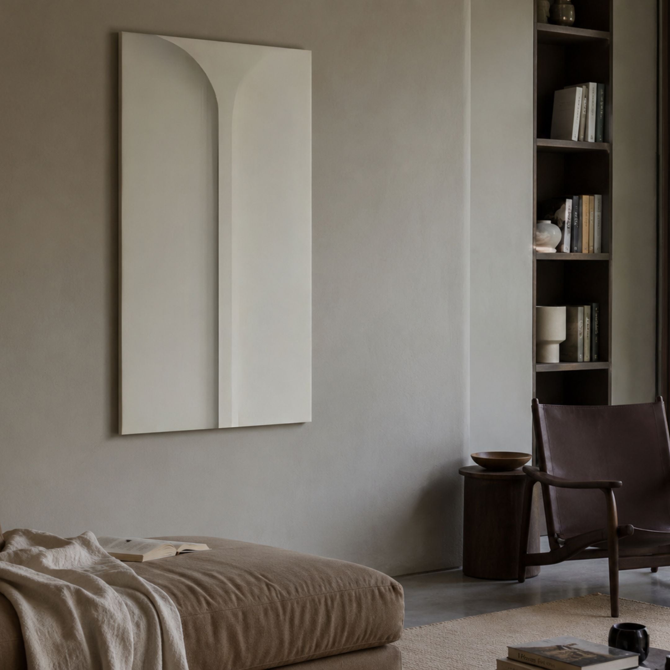 Eximia White Minimalist Wood Relief 3D Wall Art by Giant Sculptures displayed on a beige wall above a linen daybed, beside a dark bookshelf and leather chair.