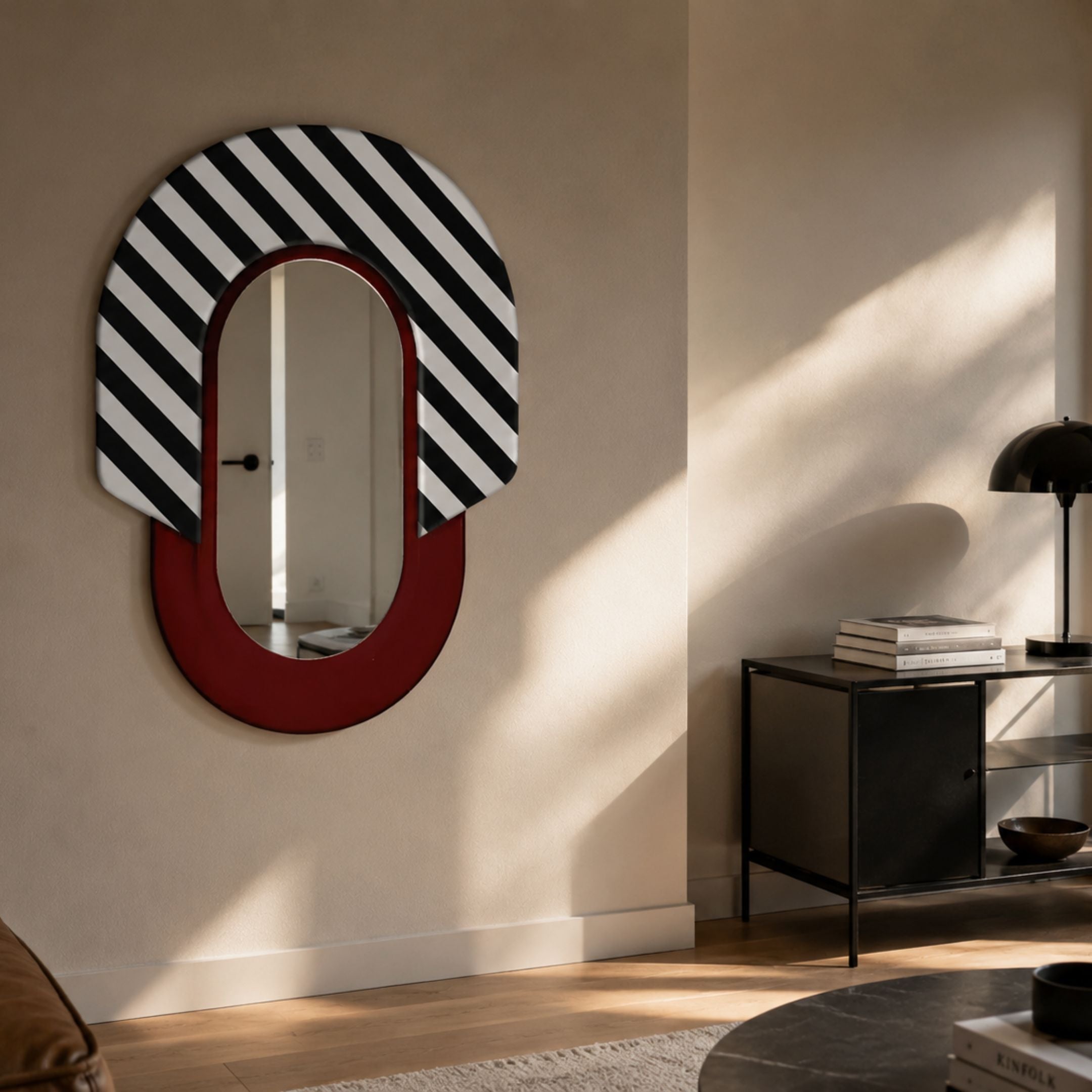 Arcus Red & Black-White Striped Mirror 3D Wooden Wall Art by Giant Sculptures displayed on a beige living room wall beside a black console table with books and lamp.