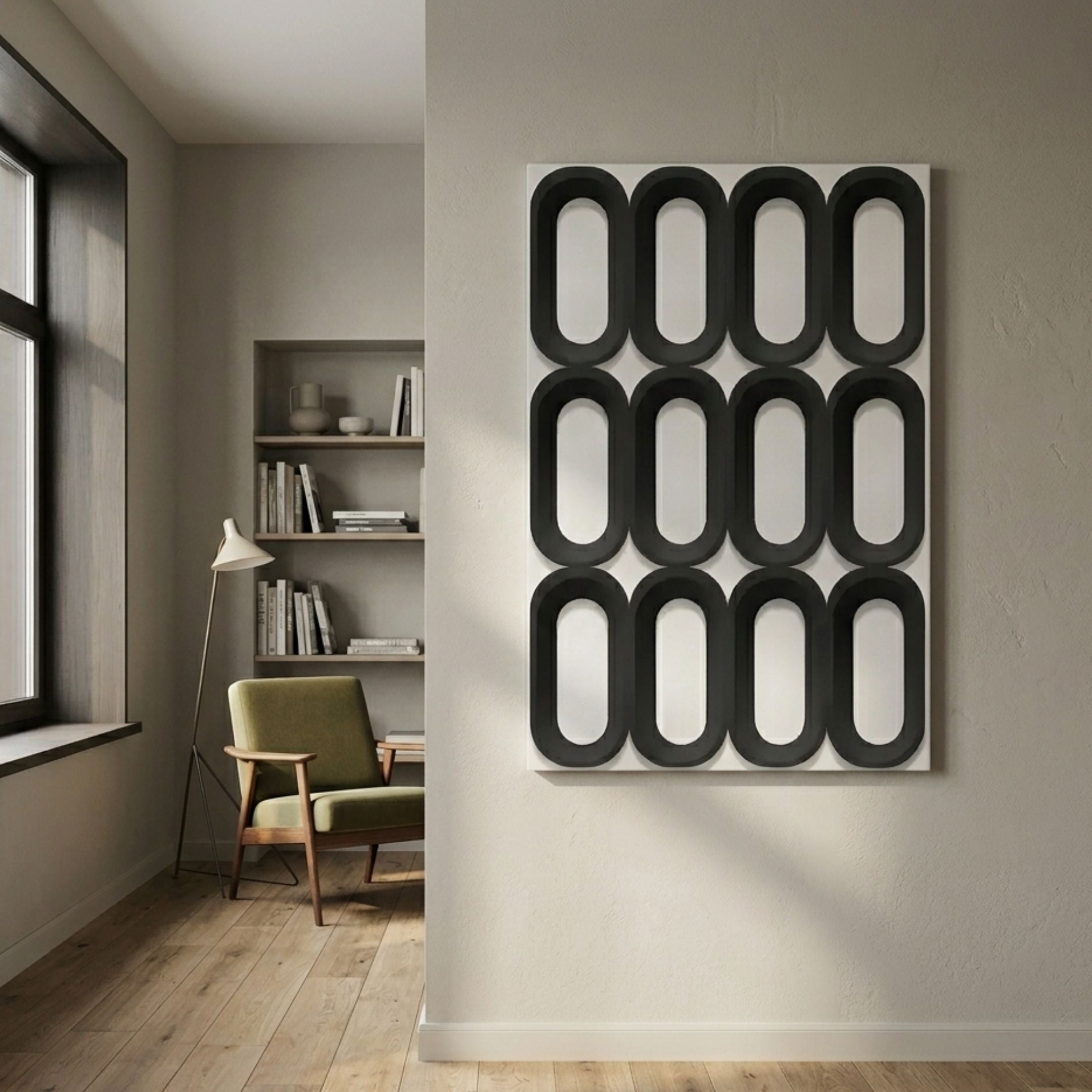 Revela White & Black Geometric Wood Relief 3D Wall Art with twelve black ovals on a light panel, mounted in a modern room with a green armchair.