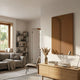 Eximia Sienna Minimalist Wood Relief 3D Wall Art by Giant Sculptures, a tall sienna-brown panel with a curved indentation, mounted in a Nordic living room.