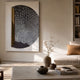 Artevia Grey & White Geometric Wood Relief 3D Wall Art with semi-circular black panel and gold accent, displayed above a daybed in a neutral living room.