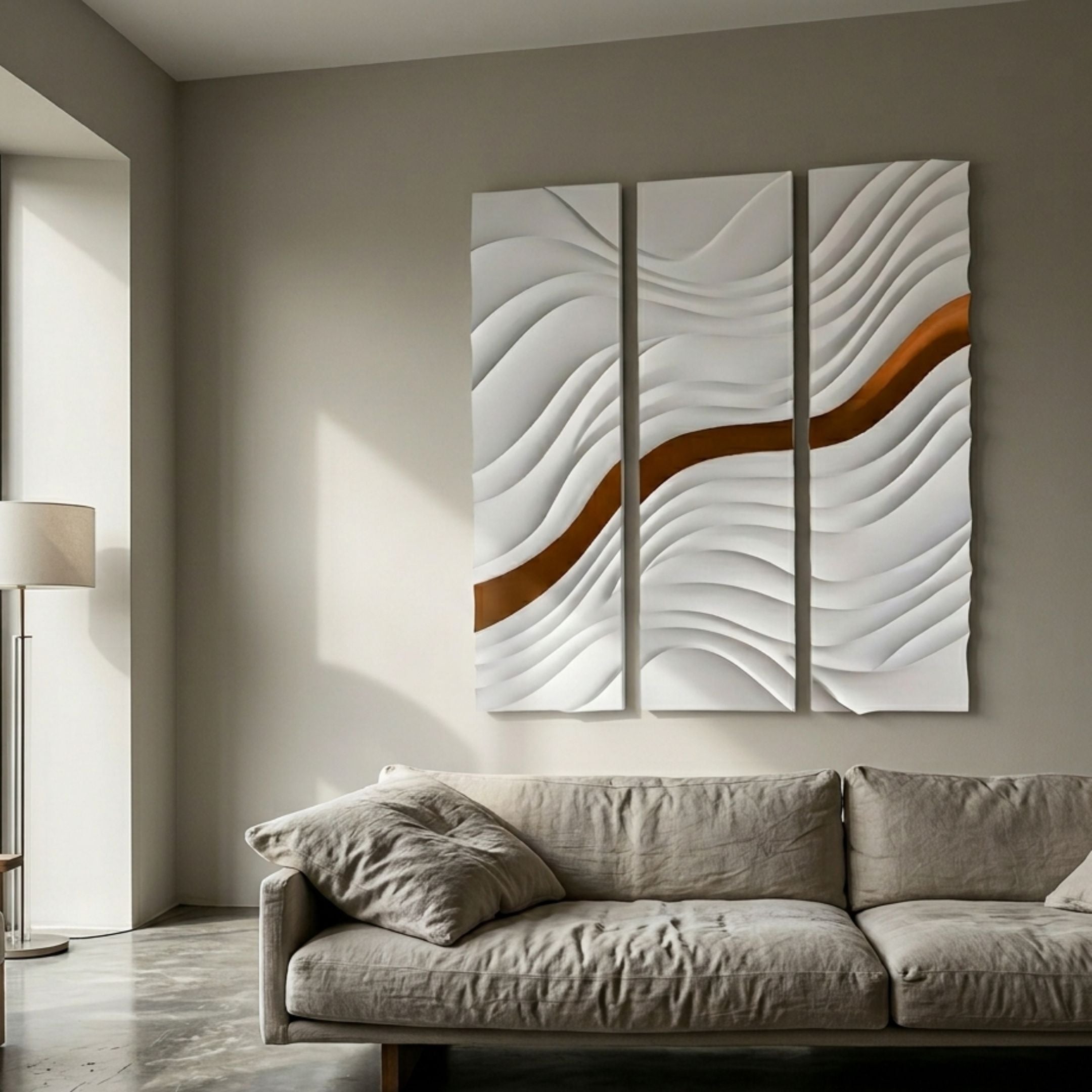 Evolva 3-Panel White & Gold Wood Relief 3D Wall Art by Giant Sculptures, mounted above a linen sofa beside a floor lamp in a neutral living room.