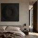 Solveta Black Spiral Wood Relief 3D Wall Art by Giant Sculptures mounted above an upholstered bed with linen bedding, beside a wooden nightstand and hallway.