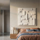 Grida Soft White Wood Carving 3D Wall Art by Giant Sculptures mounted above a wooden bedside table with lamp in a modern bedroom with terracotta and blue linens.