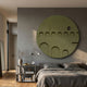 Arcuza Olive II Wood Carving Sandstone 3D Wall Art by Giant Sculptures, a round olive-green carved panel with stacked arches, mounted above a grey upholstered bed.