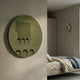 Arcuza Olive I Wood Carving Sandstone 3D Wall Art by Giant Sculptures mounted on a plaster wall beside a linen-dressed bed with a sconce in the bedroom.