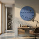 Arcuza Blue II Wood Carving Sandstone 3D Wall Art by Giant Sculptures, a matte indigo circular relief of tiered arches, displayed above a desk in a home office.