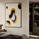 Cratera Yellow & Amber Wood Carving 3D Wall Art by Giant Sculptures, mounted in a bedroom above a wooden side table near a dark bookshelf.