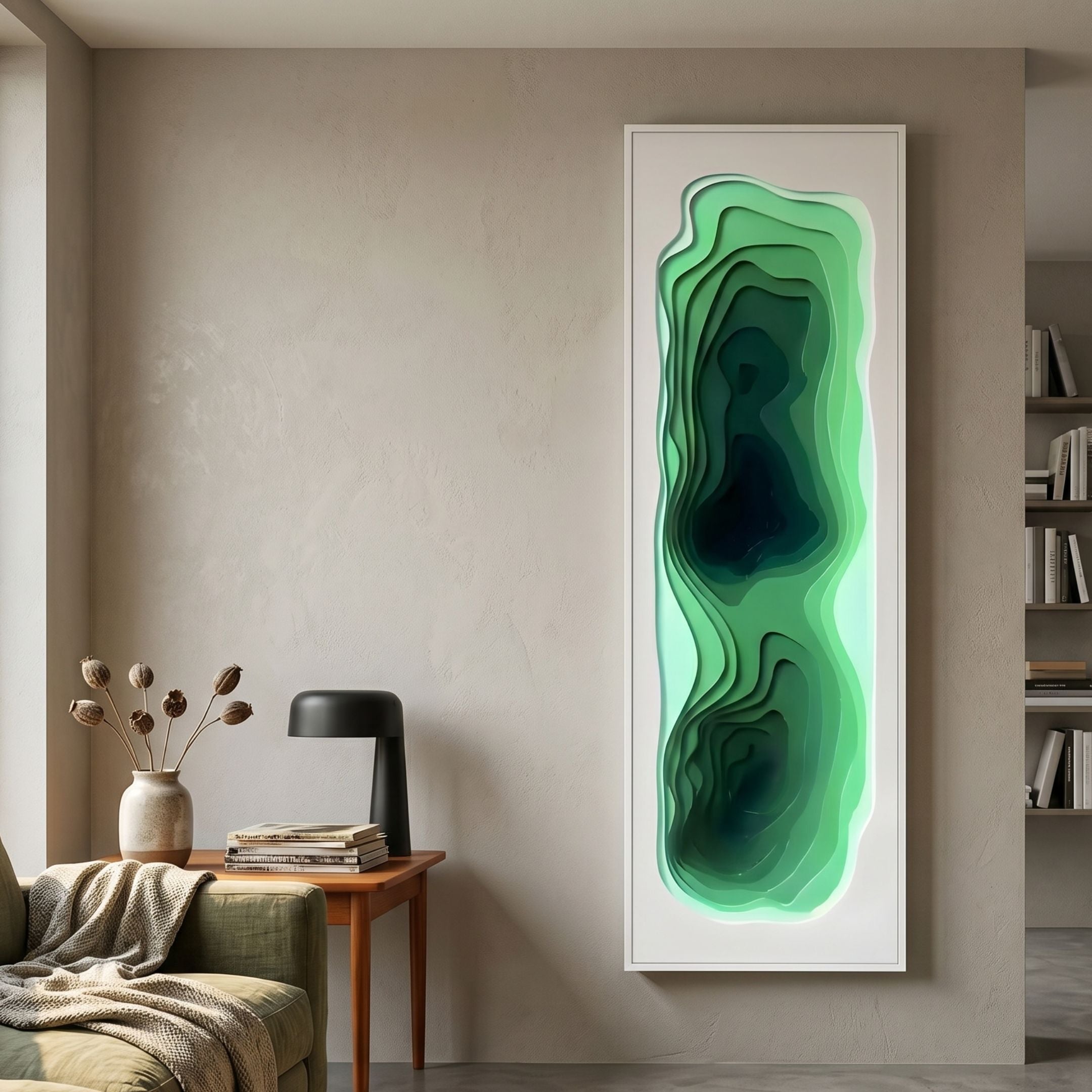Bathys Green Gradient Carved 3D Wall Art by Giant Sculptures, a tall white-framed topographic piece mounted above a wooden side table with lamp in a modern living room.