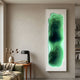 Bathys Green Gradient Carved 3D Wall Art by Giant Sculptures, a tall white-framed topographic piece mounted above a wooden side table with lamp in a modern living room.