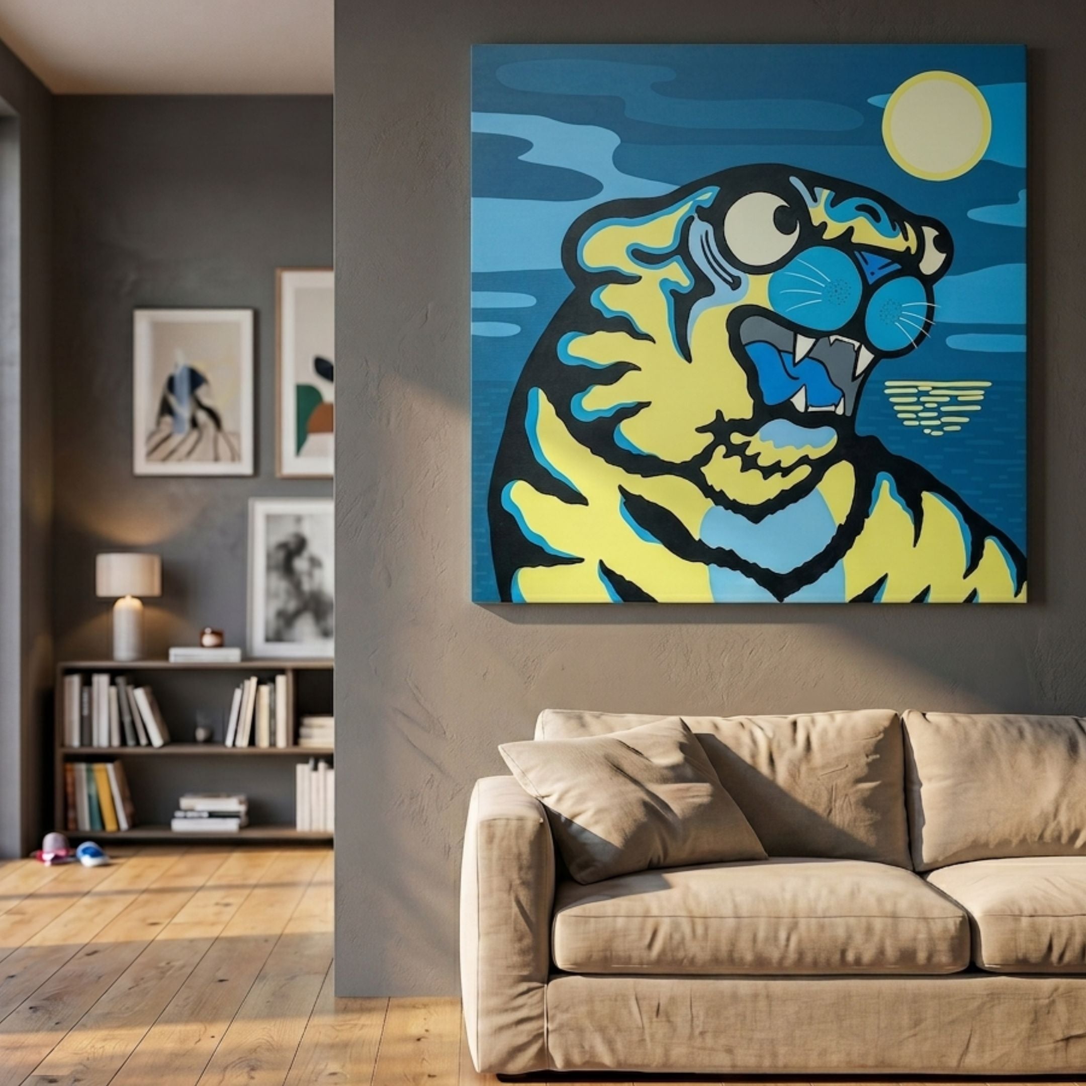 Moon Tiger Pop Art Canvas Painting by Giant Sculptures, featuring a yellow and blue cartoon tiger beneath a sun, mounted on a grey wall above a beige sofa.