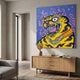 Thai Tiger Pop Art Canvas Painting in yellow, blue, and purple displayed above a wooden sideboard in a neutral living room with a grey sofa nearby.