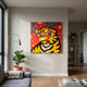 Fire Tiger Pop Art Canvas Painting by Giant Sculptures displayed on a light wall in a modern living room beside a floor lamp, fiddle leaf plant, and shelving.