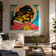 Jun Jaow Tiger Pop Art Canvas Painting by Giant Sculptures, showing a tiger in red robes and sunglasses holding a sword, displayed above a sofa in a sunlit living room.