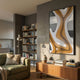 Marea Organic Flow Ochre & Silver Wood Relief 3D Wall Art by Giant Sculptures displayed in a modern living room above a walnut sideboard beside a bookshelf.