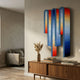 Opaline Sunset Gradient Wood Relief 3D Wall Art by Giant Sculptures, mounted above a mid-century wood sideboard in a neutral living room with pampas grass.