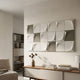 Averra White & Sage Block Wood Relief 3D Wall Art by Giant Sculptures displayed above a wooden sideboard in a neutral living room with a shelving unit.