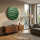 Orenda Ripple Wave Green Wood Relief 3D Wall Art mounted above a walnut sideboard in a sunlit living room with a grey sofa and floor lamp.