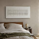 Ondara Wave White Horizontal Wood Relief 3D Wall Art mounted above a walnut bed with linen bedding, beside a wooden nightstand with a ceramic lamp.