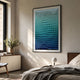Elorium Blue Gradient Hand-Painted Wood Relief 3D Wall Art with folded triangular facets, framed in black above a bedside console in a sunlit modern bedroom.