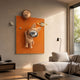 Rose Gold 3D Astronaut Bunny Balloon Orange Wall Art by Giant Sculptures displayed in a modern living room above a beige sofa beside a floor lamp.