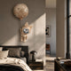 Rose Gold Astronaut Large Bunny Balloon 3D Wall Art by Giant Sculptures mounted above a bed, with the bunny tethered to a cratered moon balloon.