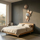 Rose Gold Astronaut Bunny Balloon 3D Wall Art by Giant Sculptures mounted above a wooden bed in a grey-walled bedroom with a window and armchair.
