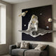 White 3D Galaxy Astronaut Thinker Starry Wall Art by Giant Sculptures mounted above a grey sofa with linen cushions in a modern Nordic living room.