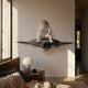White Astronaut Thinker On Rocky Shelf 3D Wall Art by Giant Sculptures mounted above a bedside table with mushroom lamp in a sunlit bedroom.