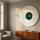 Ventus Emerald Surge Wood Carving 3D LED Wall Art by Giant Sculptures, mounted above a teak sideboard with books beside a linen armchair and window.