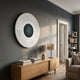 Ventus Steel Mist Wood Carving 3D LED Wall Art mounted on a dark grey wall above an oak sideboard with lamp and books in a modern living room.