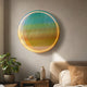 Chromia Tropical Dawn Acrylic 3D LED Wall Art by Giant Sculptures, a circular turquoise-to-yellow-orange gradient piece mounted above a bedside table and bed.