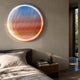 Chromia Sunrise Glow Acrylic 3D LED Wall Art by Giant Sculptures, a circular textured disc with blue-to-orange gradient glow, mounted above a bedroom nightstand.