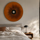 Vanguard Saffron Ember Leather 3D LED Wall Art by Giant Sculptures mounted above an upholstered bed with linen bedding, walnut nightstand, and black lamp.