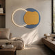 Arcadia Indigo Honey Leather 3D LED Wall Art by Giant Sculptures, with glowing white disk, indigo and honey leather circles, mounted above a sofa in a neutral living room.