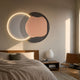 Arcadia Graphite Blush Leather 3D LED Wall Art by Giant Sculptures mounted above an oak bed, pairing a warm-glowing LED circle with a blush leather form.