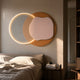 Arcadia Rose Clay Leather 3D LED Wall Art by Giant Sculptures, layered circular and organic forms in cream and rose-clay with halo LED glow above a bedroom headboard.