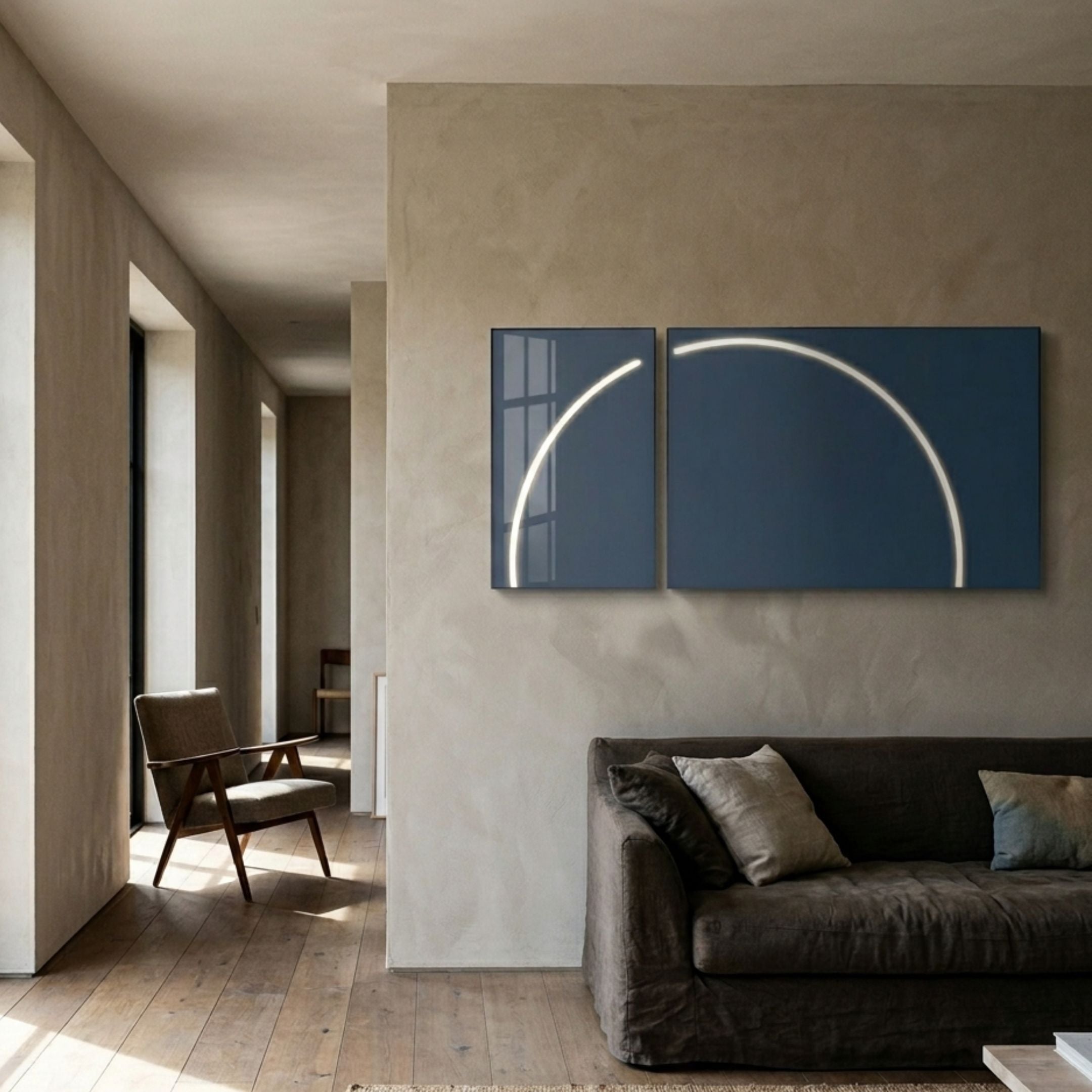 Enigma Midnight Teal LED Wall Art by Giant Sculptures displayed as two panels forming a glowing white arc on a beige plaster wall above a brown linen sofa.