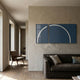 Enigma Midnight Teal LED Wall Art by Giant Sculptures displayed as two panels forming a glowing white arc on a beige plaster wall above a brown linen sofa.