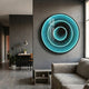 Reflex Turquoise Mirror 3D LED Wall Art by Giant Sculptures mounted on a grey wall in a modern living room with a desk, lamp, plant, and sofa.