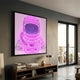Stellar Neon Orchid Acrylic 3D LED Wall Art displaying a pink neon astronaut with starry visor, mounted above a wooden console in a modern grey living room.