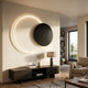 Soluna Onyx Acrylic 3D LED Wall Art by Giant Sculptures, black disc overlapping a backlit white ring, mounted above a dark wood console in a living room.