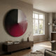 Orbit Crimson Hand-Painted Canvas 3D LED Wall Art by Giant Sculptures, circular black, white and crimson composition mounted above a walnut sideboard in a sunlit living room.