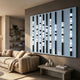 Strata Steel Blue LED Wall Art by Giant Sculptures mounted in a modern living room above a beige sofa, with eight black vertical rods glowing in cool white bands.